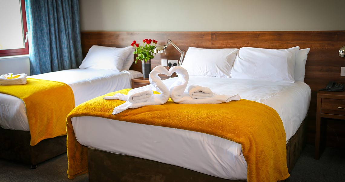 Swan folded towels on bed at Creggan Court Hotel.
