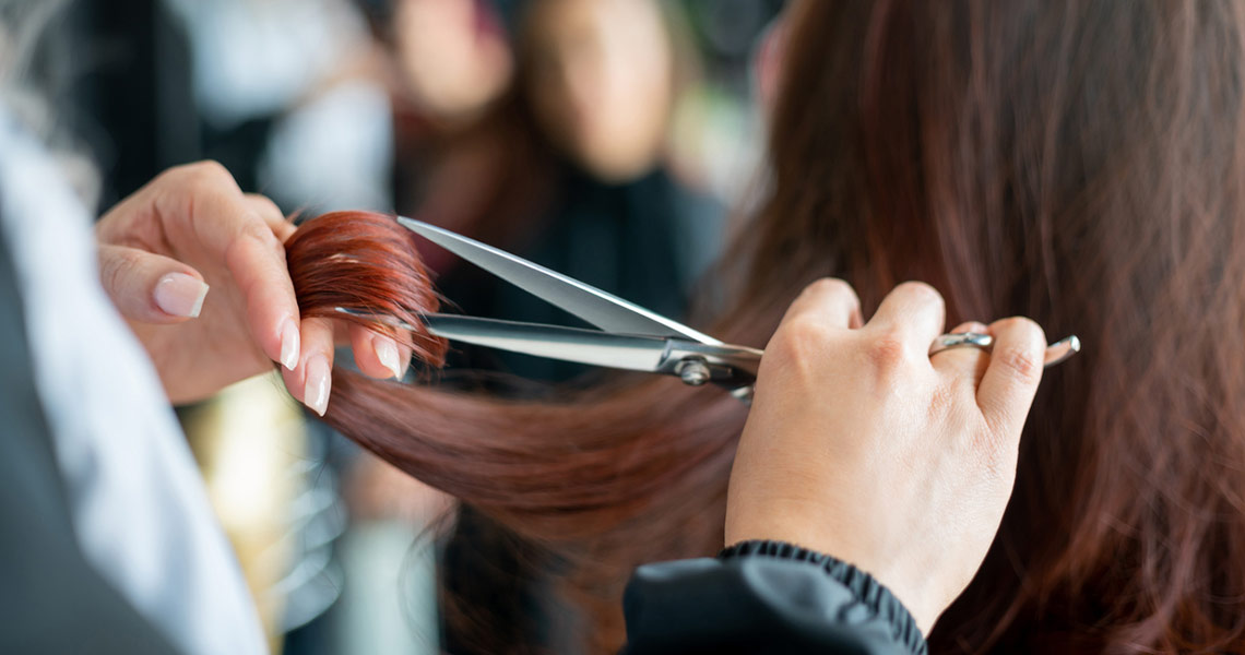 Hair stylist cutting woman's hair at Left Bank Mall.